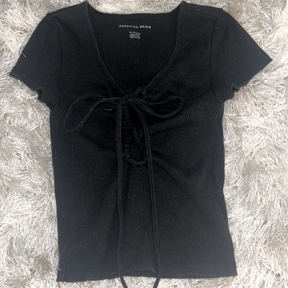 Cute black shirt with ties in the front.